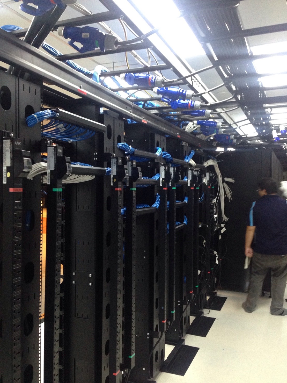 Server room corridor with multiple racks